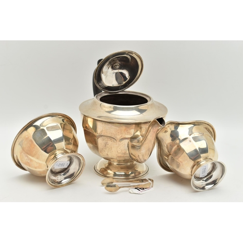 102 - AN EDWARDIAN SILVER THREE PIECE TEA SET, faceted design, comprising of a teapot, fitted with an ebon... 