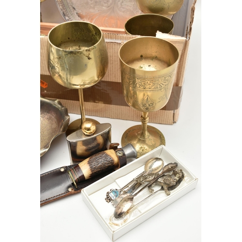 125 - A BOX OF ASSORTED WHITE METAL WARE, to include a circular tray, brass goblets, goblets, pewter tanka... 