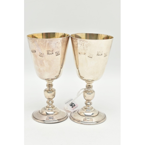 95 - A PAIR OF ELIZABETH II SILVER GOBLETS, tapered design with engraved crest, stamped '672 1972', knopp... 