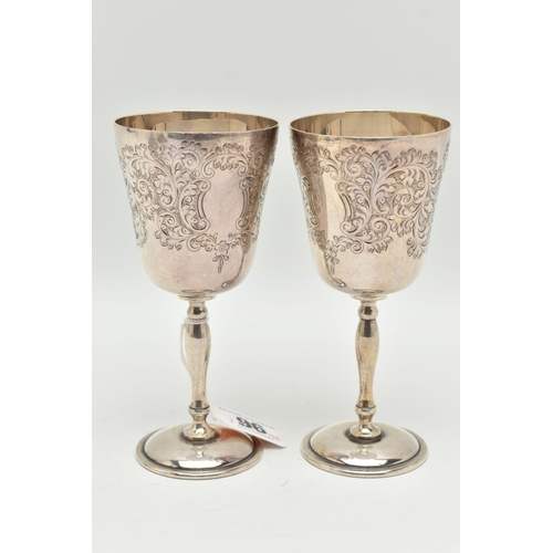 96 - A PAIR OF ELIZABETH II SILVER GOBLETS, foliate engraved pattern to the cup with vacant cartouche, gi... 