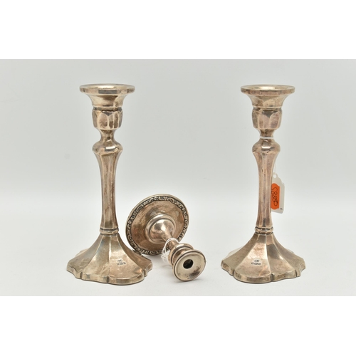 98 - A PAIR OF ELIZABETH II SILVER CANDLESTICKS AND A DWARF CANDLE STICK, the first faceted pair of candl... 