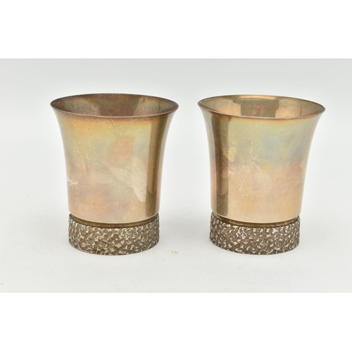 99 - A PAIR OF ELIZABETH II SILVER BEAKERS, textured rims to the base, gilt exterior, hallmarked to the b... 