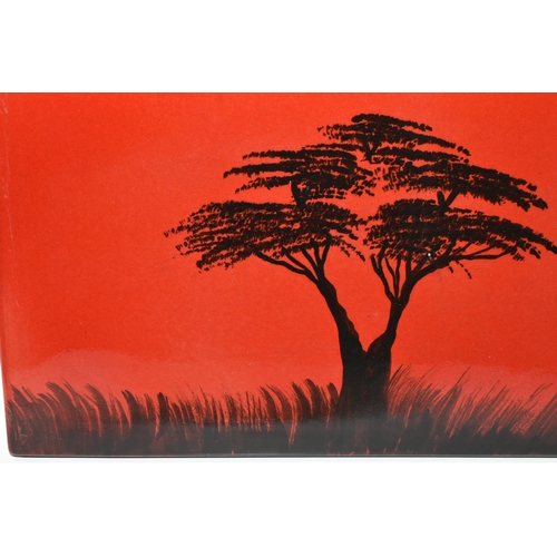 366 - A POOLE POTTERY 'AFRICAN SKY' WALL PANEL, depicting silhouetted tree and clouds on a red/orange grou... 