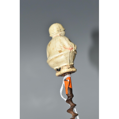 457 - A 1920S NOVELTY CORKSCREW, the celluloid handle in the form of a chubby huntsman, height of figure 5... 