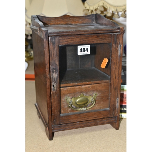 484 - AN EDWARDIAN SMOKER'S CABINET,  oak cased, glazed door and brass handled internal drawer, height 38c... 