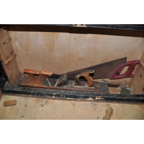 1062 - A WOODEN CARPENTERS TOOL BOX containing a 22in wooden plane (shows signs of woodworm), two saws, a M... 