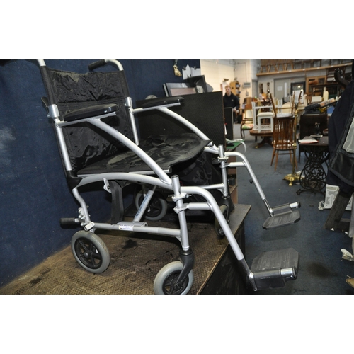 1070 - AN ENIGMA FOLDING WHEELCHAIR with footrests and carry bag along with an Aidapt travelator (2)