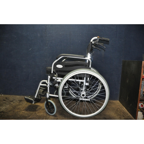 1105 - AN ELITE CARE FOLDING WHEELCHAIR with two footrests and padded seat cushion