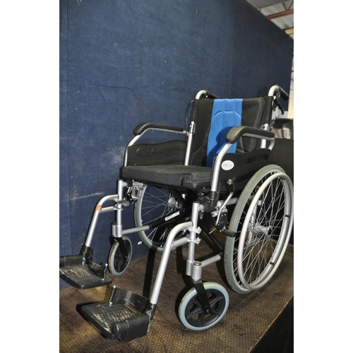 1105 - AN ELITE CARE FOLDING WHEELCHAIR with two footrests and padded seat cushion