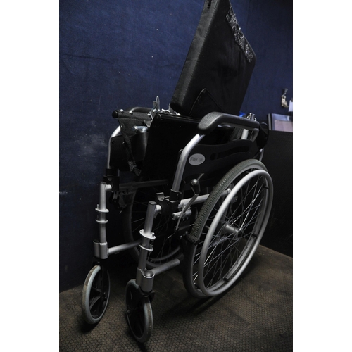 1105 - AN ELITE CARE FOLDING WHEELCHAIR with two footrests and padded seat cushion