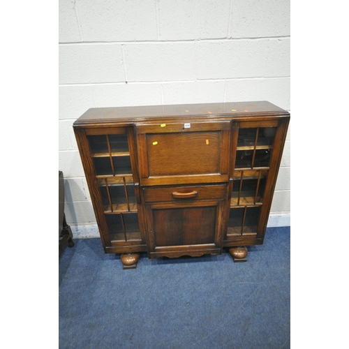 1212 - A 20TH CENTURY OAK SIDE BY SIDE BUREAU BOOKCASE, the fall front door enclosing a fitted interior, ab... 