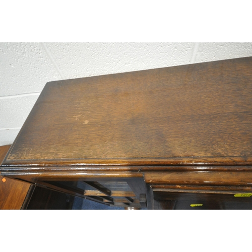 1212 - A 20TH CENTURY OAK SIDE BY SIDE BUREAU BOOKCASE, the fall front door enclosing a fitted interior, ab... 