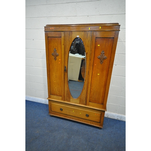 1328 - A 20TH CENTURY OAK WARDROBE, with a single mirror door, above a single drawer, on bun feet, width 12... 