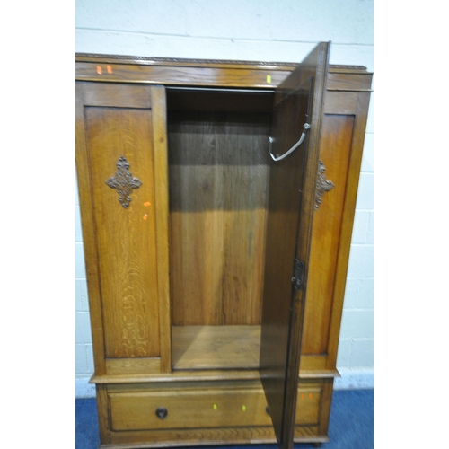 1328 - A 20TH CENTURY OAK WARDROBE, with a single mirror door, above a single drawer, on bun feet, width 12... 