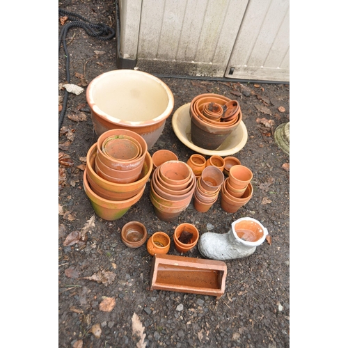 1021 - A COLLECTION OF TWO GLAZED PLANTERS AND A QUANTITY OF TERRACOTTA POTS of various sizes including a t... 