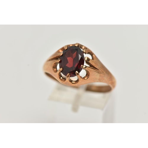 10 - A 9CT GOLD GARNET RING, an oval cut garnet prong set in yellow gold, hallmarked 9ct Chester, ring si... 