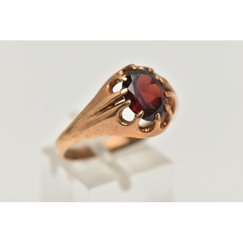 10 - A 9CT GOLD GARNET RING, an oval cut garnet prong set in yellow gold, hallmarked 9ct Chester, ring si... 