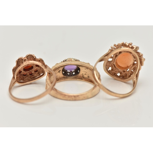 14 - THREE 9CT YELLOW GOLD GEM SET DRESS RINGS, to include a garnet cluster ring, an amethyst single ston... 