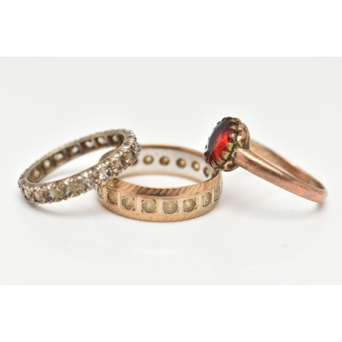 24 - THREE ASSORTED RINGS, to include a 9ct gold and spinel full set eternity band ring, approximate widt... 