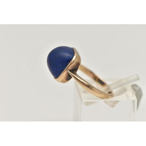 35 - A LAPIS LAZULI RING, designed as a square lapis lazuli cabochon in a collet setting to the plain ban... 