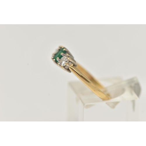 41 - AN 18CT GOLD EMERALD AND DIAMOND RING, the central oval emerald flanked by brilliant cut diamonds, a... 