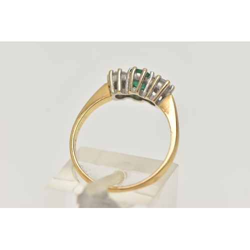 41 - AN 18CT GOLD EMERALD AND DIAMOND RING, the central oval emerald flanked by brilliant cut diamonds, a... 