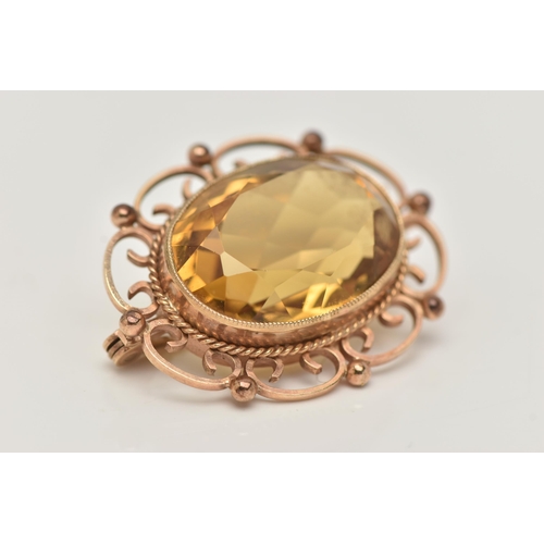 56 - A 9CT GOLD CITRINE BROOCH, of an oval form, set with a large oval cut citrine, in a milgrain collet ... 