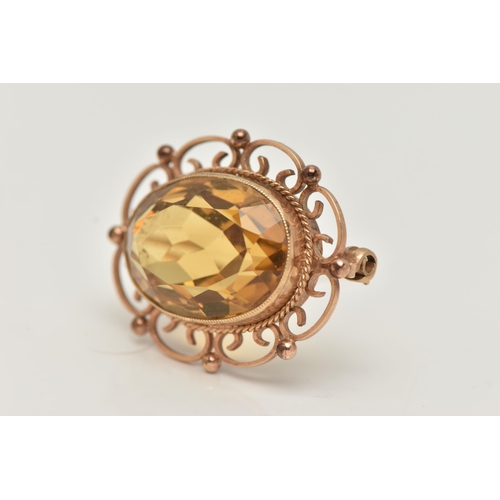 56 - A 9CT GOLD CITRINE BROOCH, of an oval form, set with a large oval cut citrine, in a milgrain collet ... 