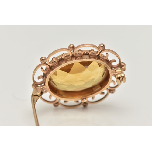 56 - A 9CT GOLD CITRINE BROOCH, of an oval form, set with a large oval cut citrine, in a milgrain collet ... 