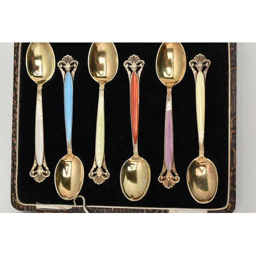 123 - A CASED SET OF TEASPOONS AND A SCENT BOTTLE, a set of six gilt metal and colourful enamel teaspoons,... 