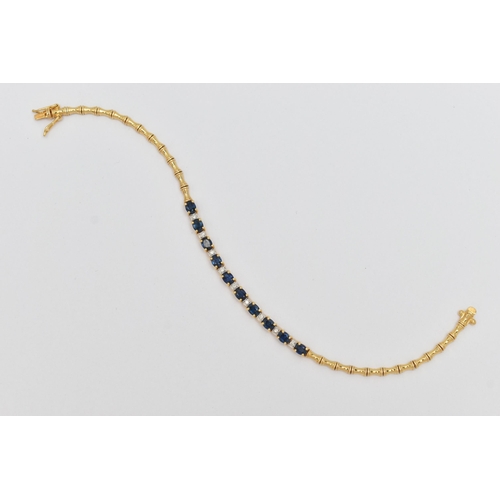 64 - A SAPPHIRE AND DIAMOND BRACELET, designed as a central section of ten oval cut sapphires interspaced... 