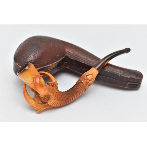 68 - AN AMBER AND MEERSCHAUM PIPE, in the form of an eagle talon gripping an amber chamber with amber mou... 