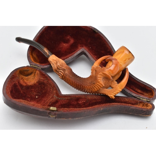 68 - AN AMBER AND MEERSCHAUM PIPE, in the form of an eagle talon gripping an amber chamber with amber mou... 