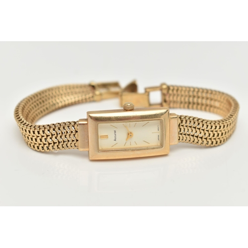 69 - A LADY'S 9CT GOLD ACCURIST WRISTWATCH, the rectangular cream face with gold colour baton markers and... 