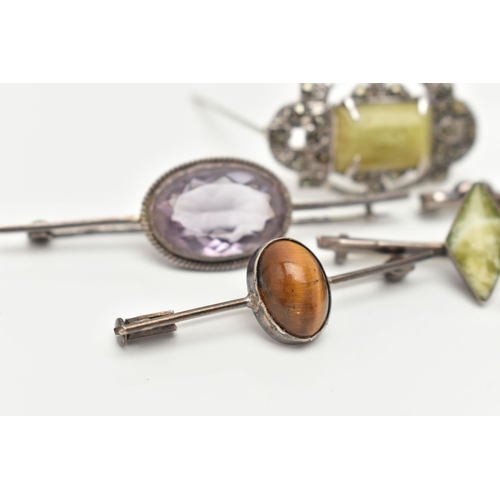 92 - SIX WHITE METAL BROOCHES, three set with green hardstones each stamped 'silver', an amethyst cabocho... 