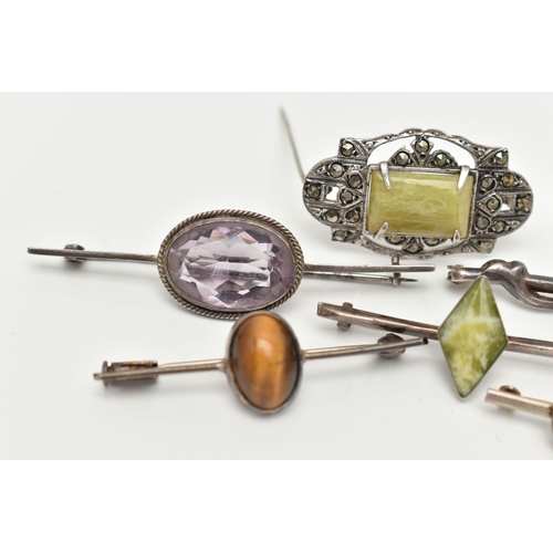 92 - SIX WHITE METAL BROOCHES, three set with green hardstones each stamped 'silver', an amethyst cabocho... 