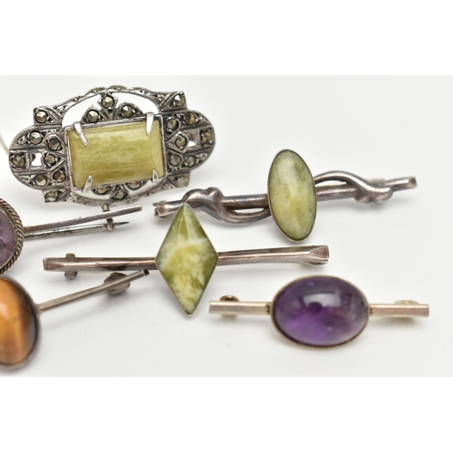 92 - SIX WHITE METAL BROOCHES, three set with green hardstones each stamped 'silver', an amethyst cabocho... 