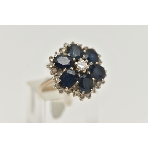 149 - A LARGE 18CT GOLD SAPPHIRE AND DIAMOND CLUSTER RING, six oval cut sapphires and a central round bril... 