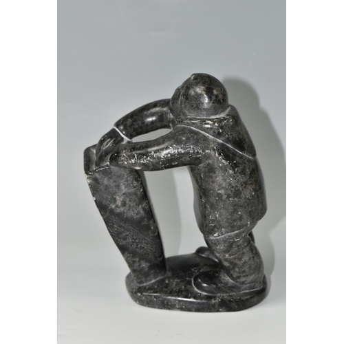 634 - A CANADIAN INUIT SOAPSTONE CARVING, of an Inuit fisherman, height approx. 20cm, inscribed marks to b... 