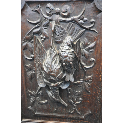 1198 - A LATE 19TH / EARLY 20TH CENTURY CARVED OAK GLAZED BOOKCASE, depicting lions masks and other detail,... 