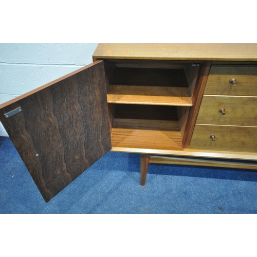 1204 - POSSIBLY GORDON RUSSELL, A MID CENTURY TEAK SIDEBOARD, fitted with two cupboard doors, flanking thre... 