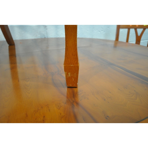 1206 - A 20TH CENTURY YEW WOOD OVAL TWIN PEDESTAL EXTENDING DINING TABLE, with one additional leaf, extende... 