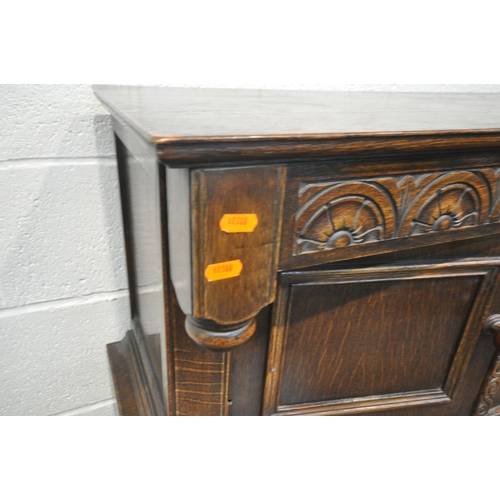 1212 - A 20TH CENTURY OAK COURT CUPBOARD, with repeating arched details, two doors, above two drawers and t... 