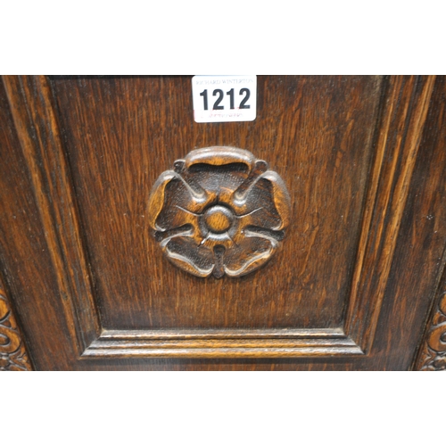 1212 - A 20TH CENTURY OAK COURT CUPBOARD, with repeating arched details, two doors, above two drawers and t... 