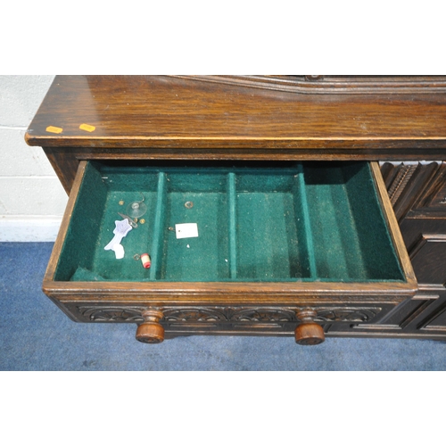 1212 - A 20TH CENTURY OAK COURT CUPBOARD, with repeating arched details, two doors, above two drawers and t... 