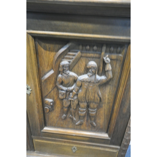 1213 - A 20TH CENTURY OAK CABINET, with two cupboard doors, carved with men in two different settings, abov... 