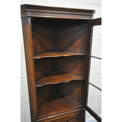 1239 - A TITCHMARSH AND GOODWIN OAK CORNER CUPBOARD, a single glazed door, above a cupboard door, width 70c... 