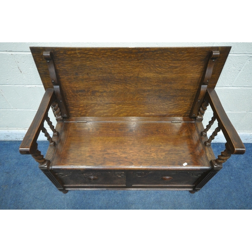 1244 - A 20TH CENTURY OAK MONKS BENCH, with a rise and fall back rest/surface, raised on barley twist suppo... 