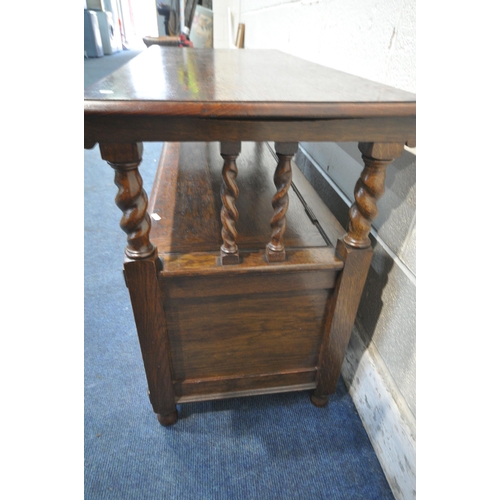 1244 - A 20TH CENTURY OAK MONKS BENCH, with a rise and fall back rest/surface, raised on barley twist suppo... 