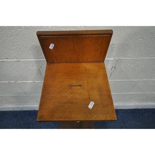 1258 - A 20TH CENTURY OAK CHURCH COLLECTION BOX, with a raised back, small money slot, raised on a tapered ... 